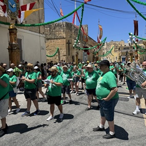 Marching brass band performing during a traditional village festa in Malta