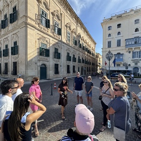 Travelers taking a guided walking tour through historic Valletta, Malta