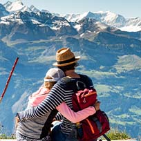 Two people hugging looking over a mountain top